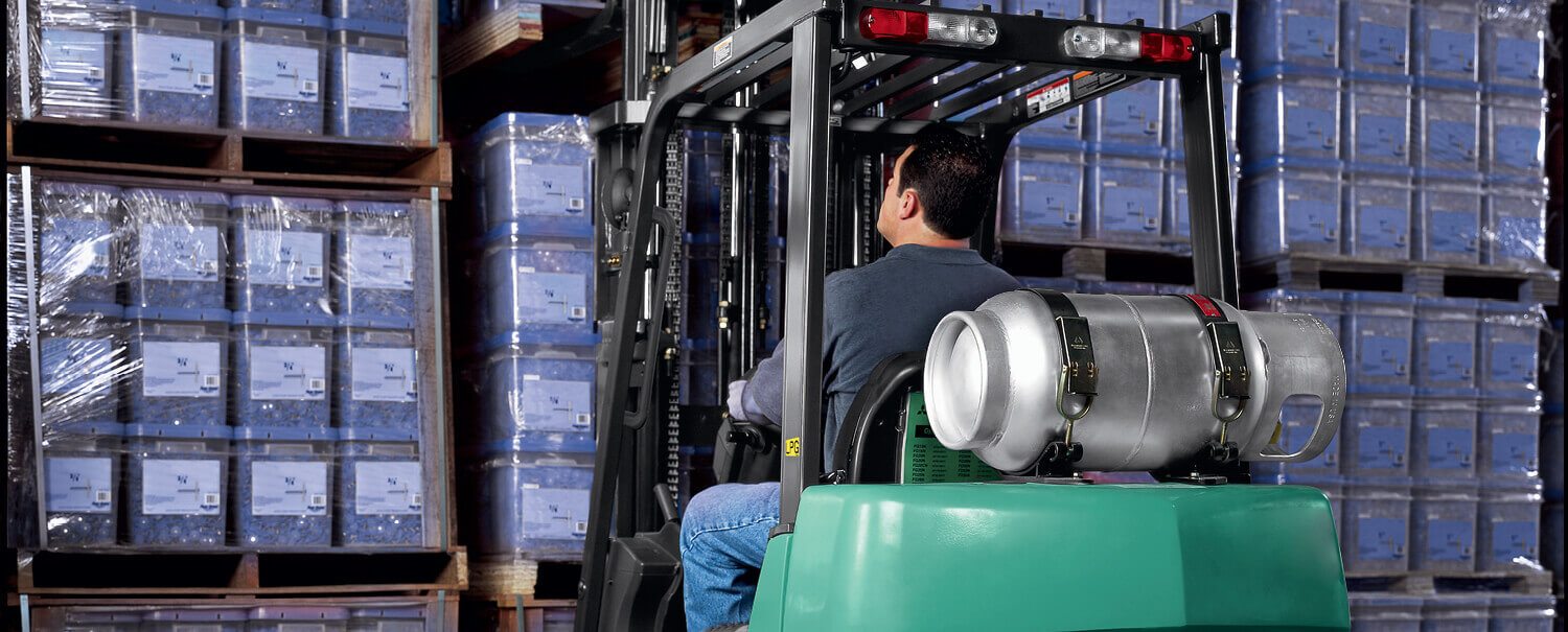 Man driving Mitsubishi IC cushion tire forklift away